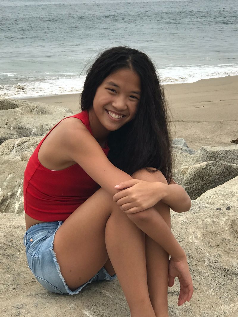 Charlie Kersh sitting near a beach and smiling